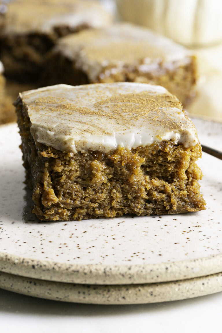a close up of a slice of pumpkin olive oil cake on a stack of 2 plates.