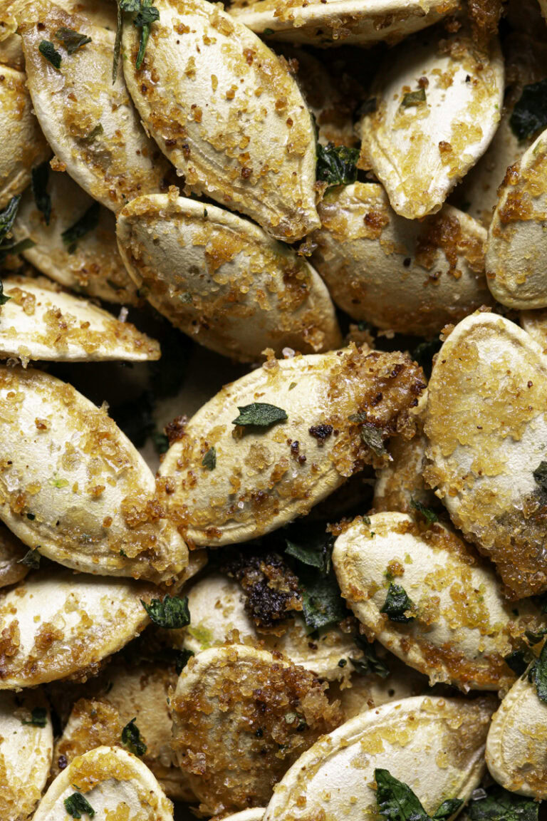 close up of vegan garlic parmesan roasted pumpkin seeds.