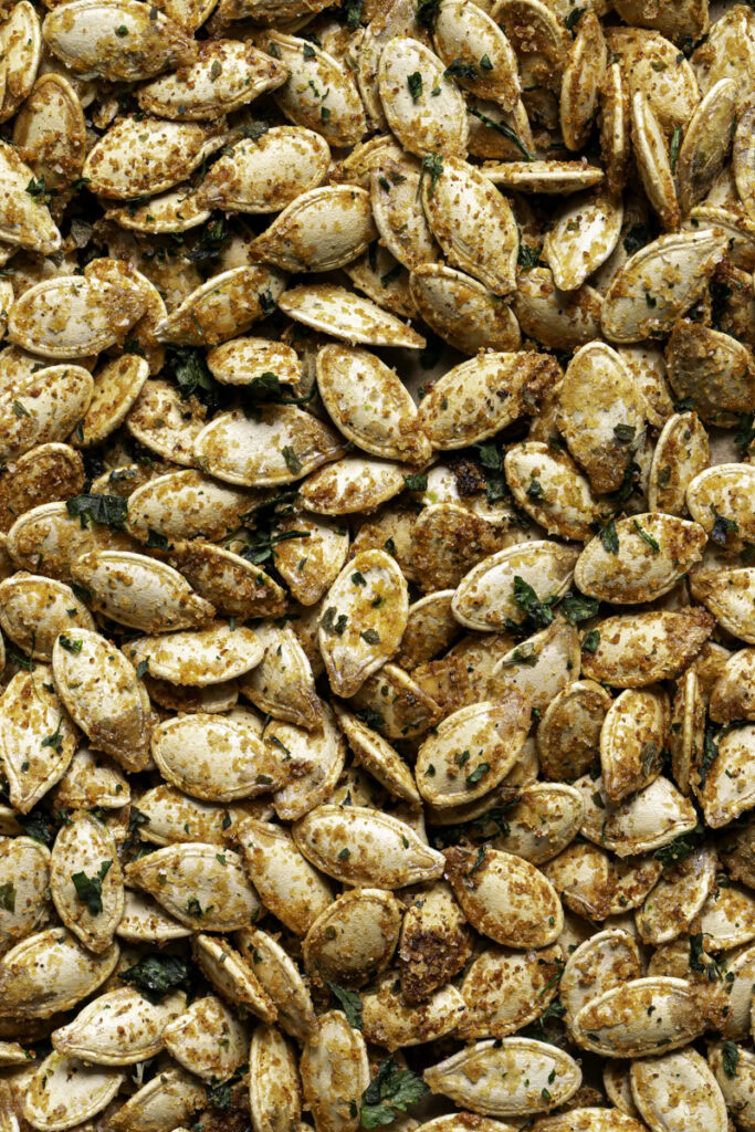 vegan garlic parmesan roasted pumpkin seeds on a baking sheet.