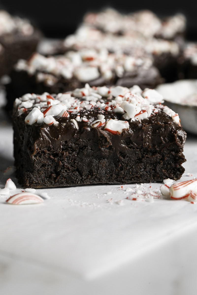 a close up of a Fudgy Flourless Peppermint Date Brownie.