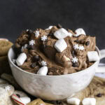 close up of creamy vegan hot cocoa dip in a mug.