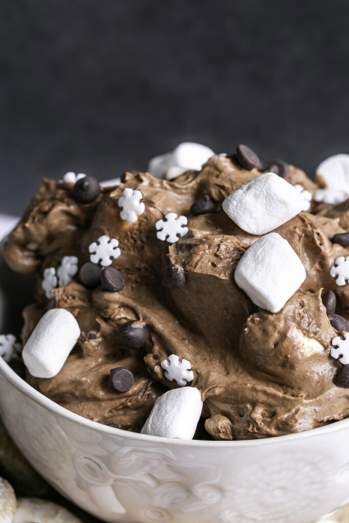 very close up of creamy vegan hot cocoa dip in a mug.