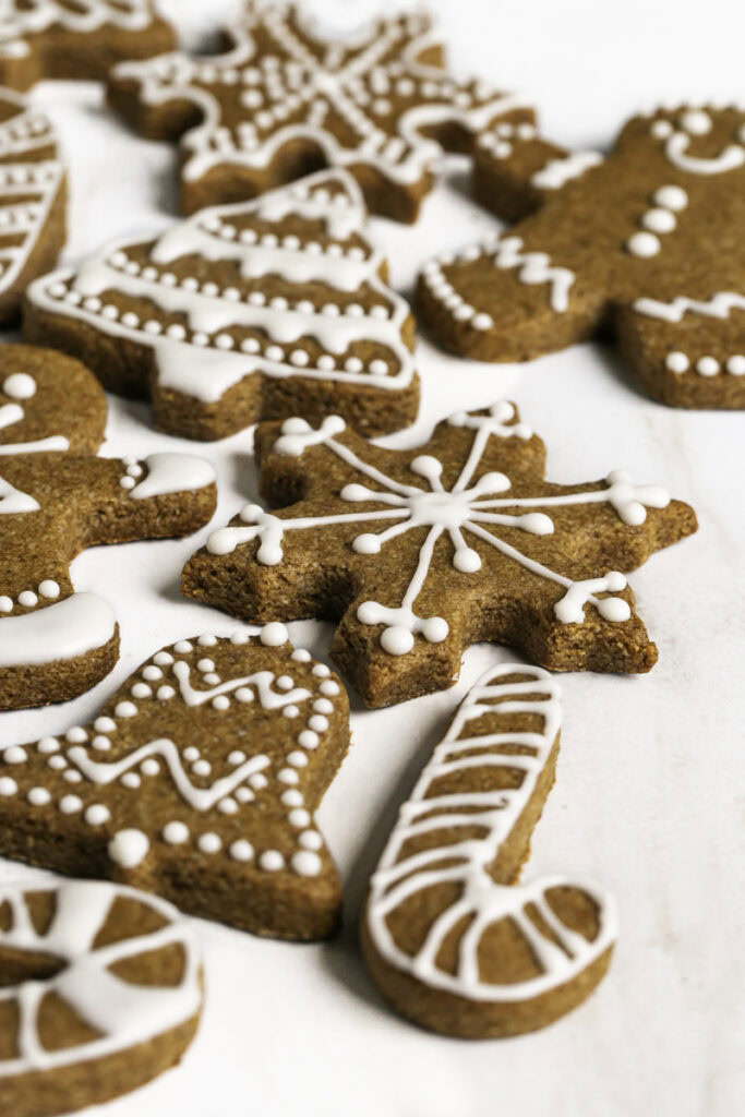 3/4 shot of decorated Soft & Chewy Almond Flour Date Gingerbread Cookies.