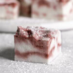 a single Vegan Peppermint Swirl Marshmallow with more marshmallow squares behind it.