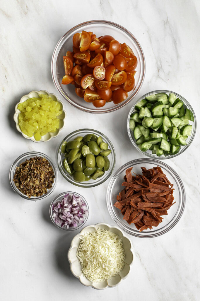 Seperate glass bowls with the salad ingredients.
