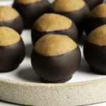 vegan buckeyes sitting separately on a plate.