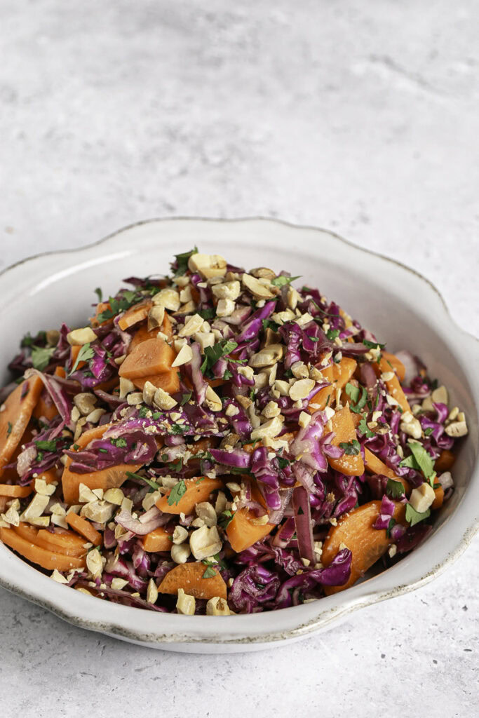 a bowl of Vietnamese Coleslaw with roasted peanuts.