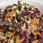 a close up image of a bowl of Vietnamese Coleslaw with roasted peanuts.