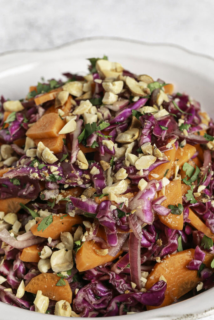 a close up image of a bowl of Vietnamese Coleslaw with roasted peanuts.