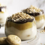 close up of Samoas Yogurt Dessert Cups with shredded toasted coconut and mini vanilla cookies.