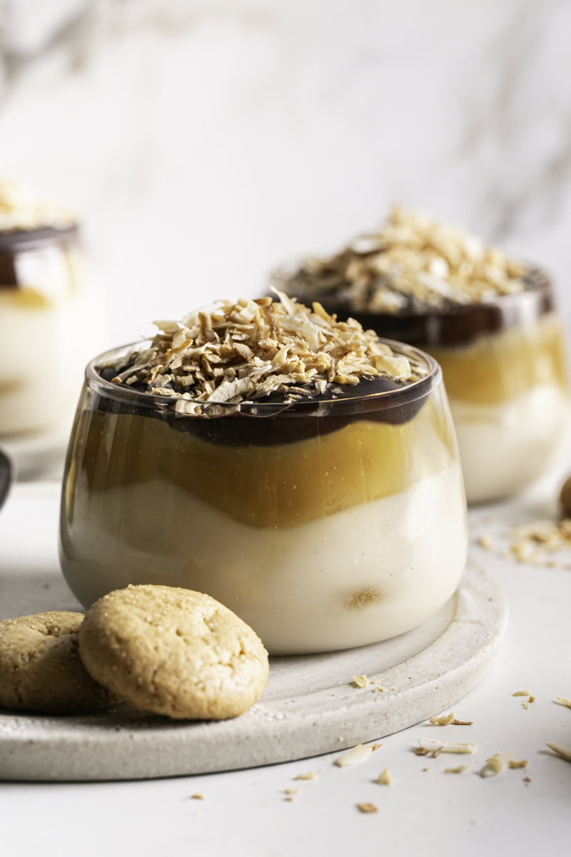 close up of Samoas Yogurt Dessert Cups with shredded toasted coconut and mini vanilla cookies.