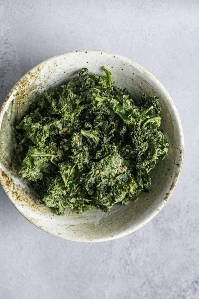 Overhead shot of Cheesy Nutritional yeast Kale Chips in a bowl.