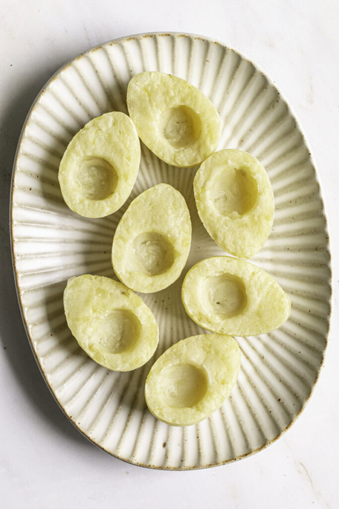 unfilled mashed potato "eggs" on a plate.