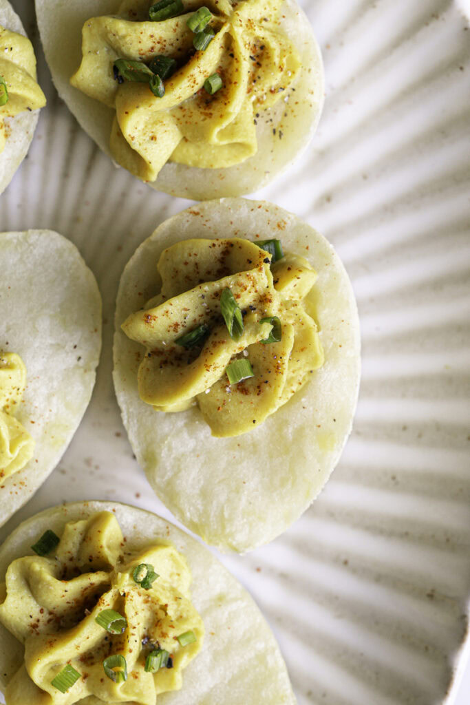 close up overhead shot of deviled mashed potato "eggs" on a plate.