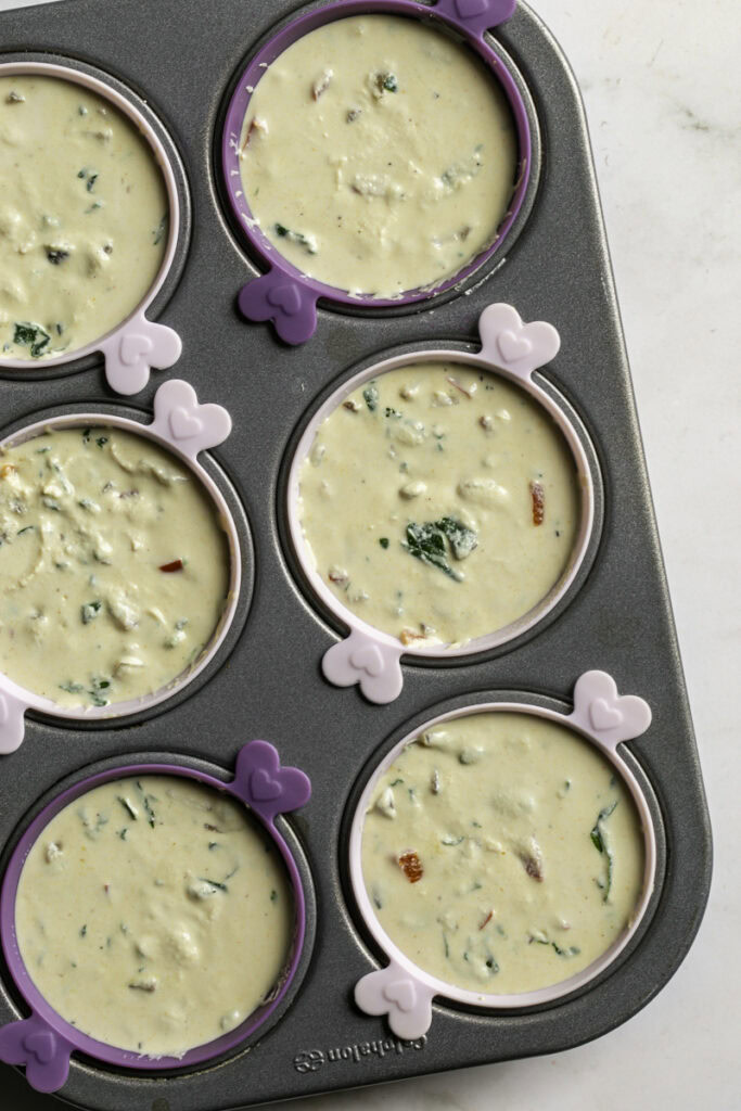 the tofu "egg" mixture spooned into a silicone lined muffin tin ready to be baked.
