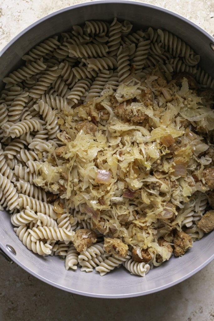 the sauerkraut bratwurst mixture added to the pot with the pasta.