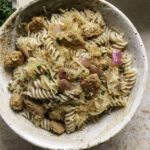 a close up of a bowl of vegan Bratwurst & Sauerkraut Pasta.