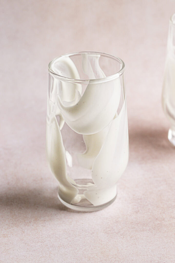 a glass with yogurt spread up the inside to create a swirl effect.