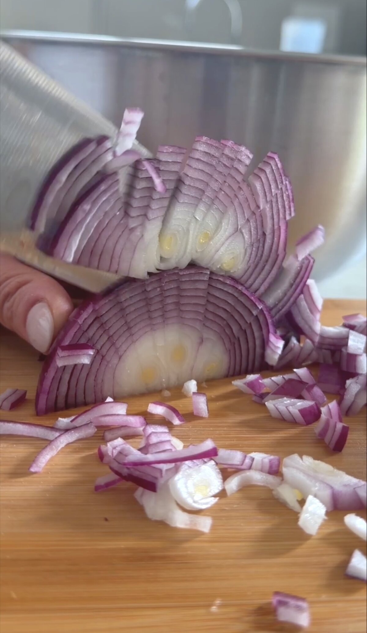 action shot slicing red onion.