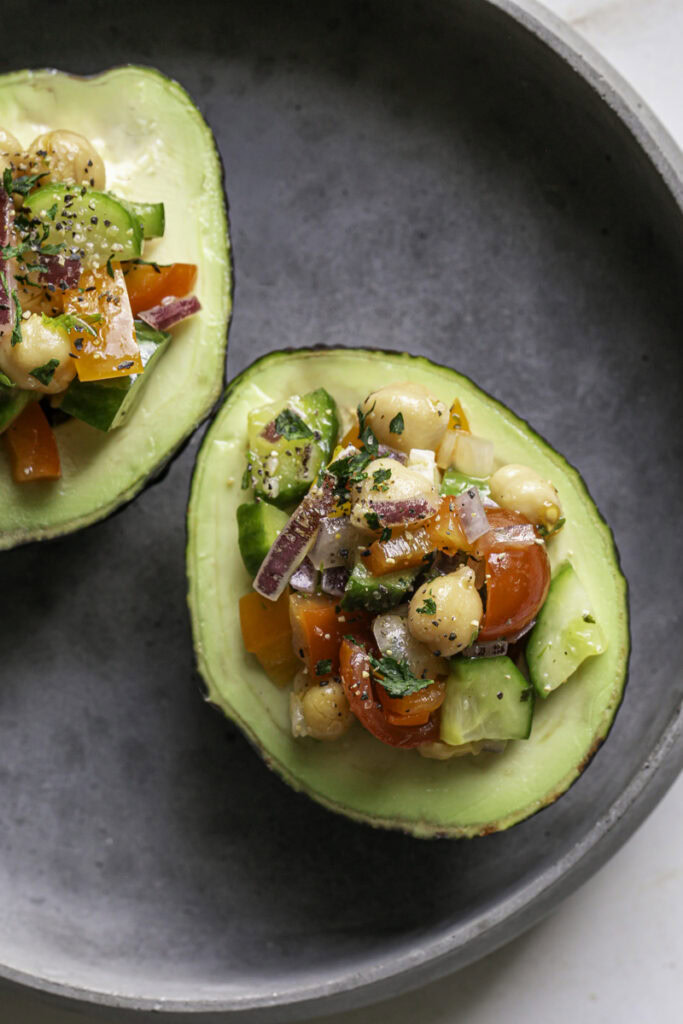 chickpea salad served inside avocado halves.