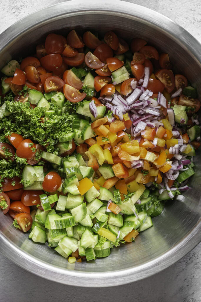 all of the chickpea salad ingredients in a large bowl unmixed.