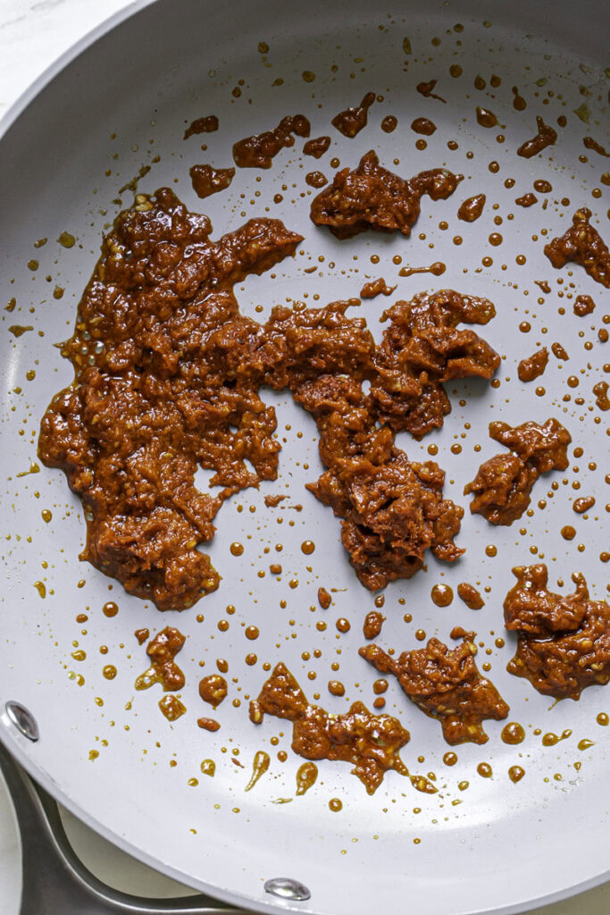 red curry paste and ground ginger combined with the garlic and olive oil in the skillet.