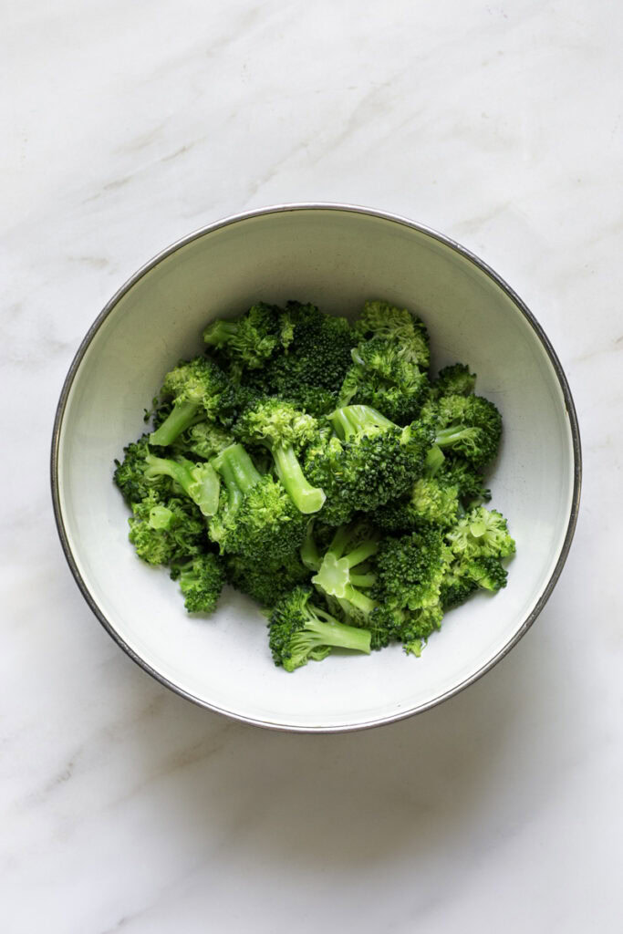 steamed broccoli florets in a bowl.