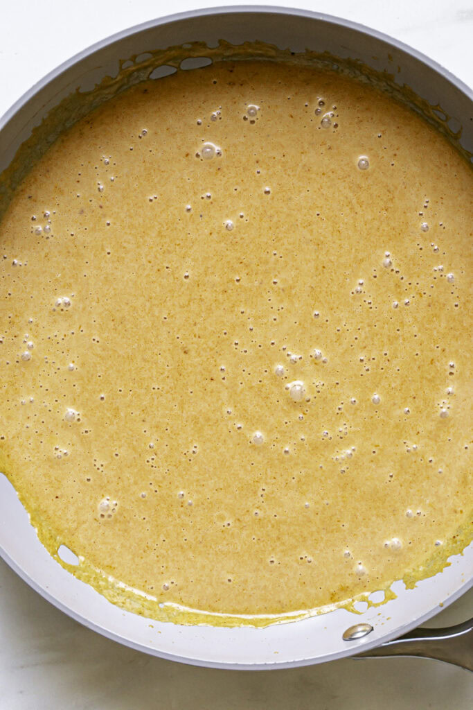 coconut curry sauce in a skillet.