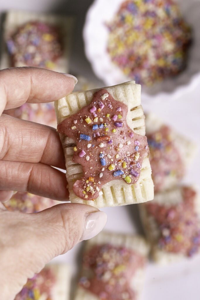 a hand holding a mini pop tart.