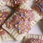 close up of mini strawberry chia pop tarts piled on top of one another.