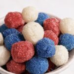 Sour Red White Blue Frozen Grapes piled in a bowl.