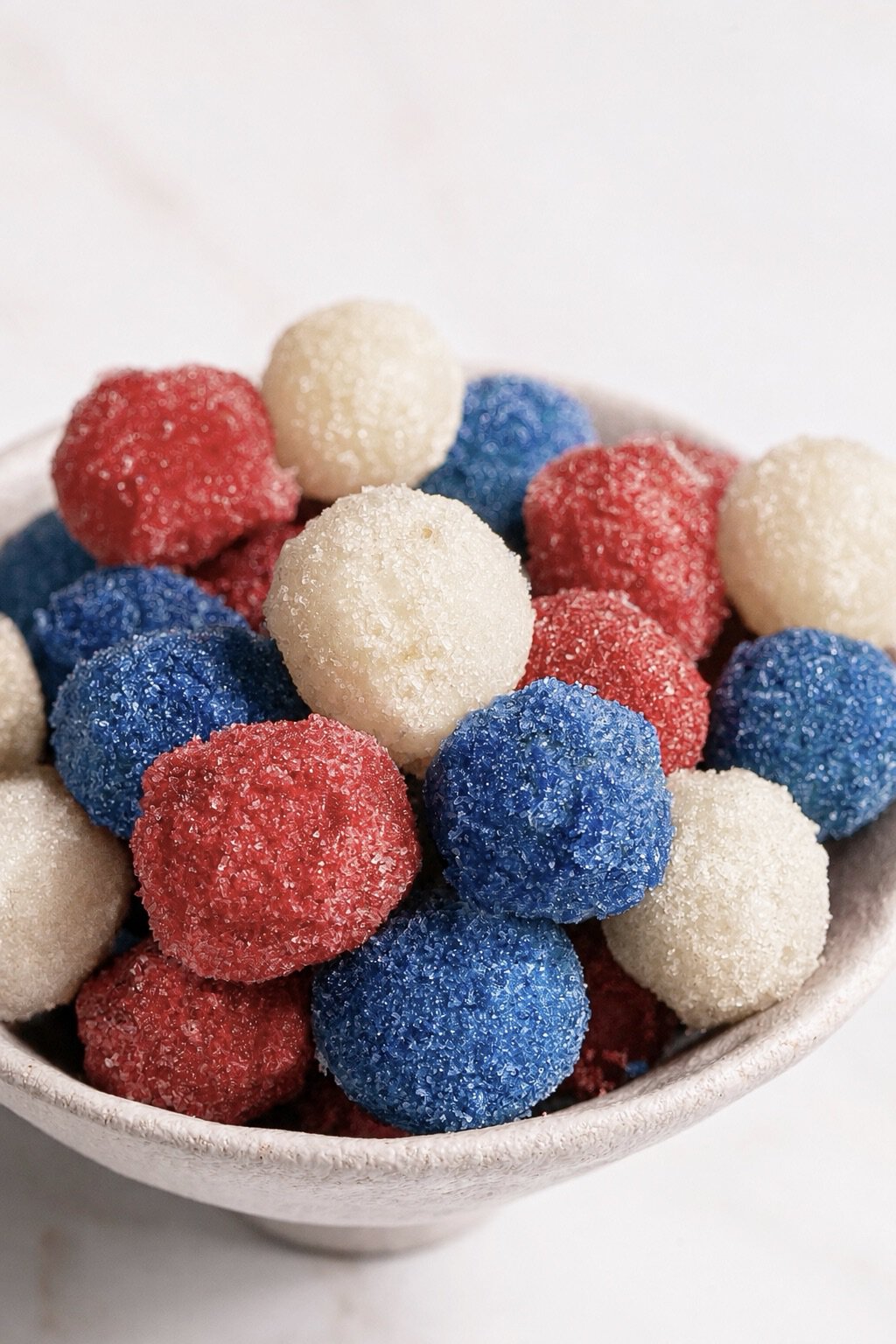 Sour Red White Blue Frozen Grapes piled in a bowl.