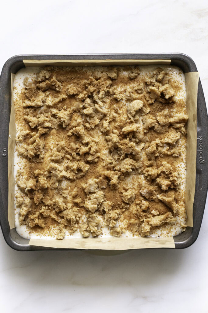 cinnamon sugar and remaining cookie crumb sprinkled over top of the cheesecake layer.