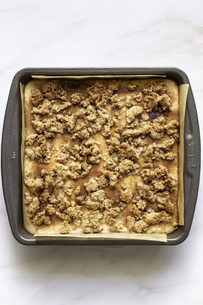 baked cinnamon cookie cheesecake crumb bars in the baking pan.
