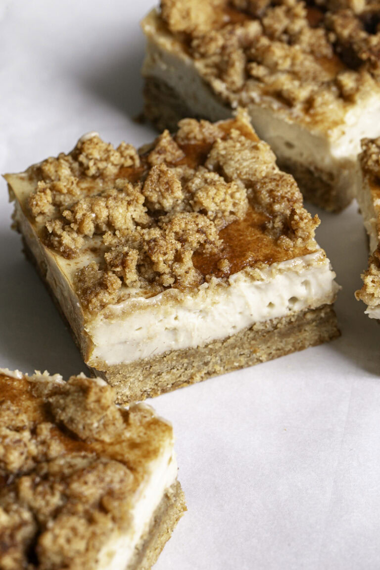 a close up of a slice of cinnamon cookie cheesecake crumb bar.