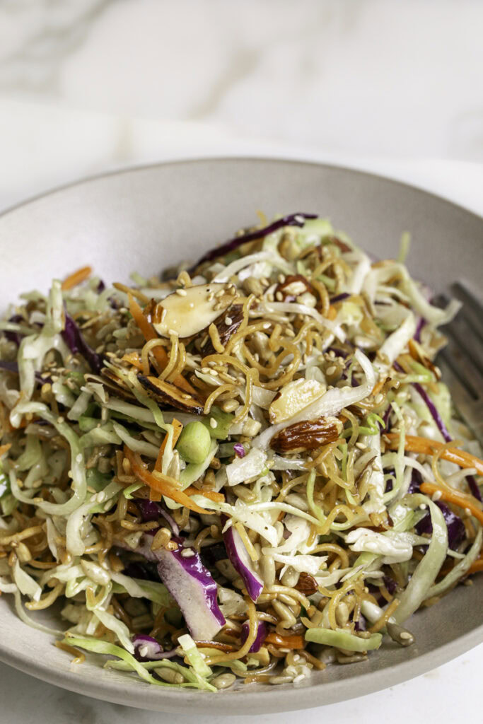 close up of crunchy ramen noodle cabbage salad in a bowl.