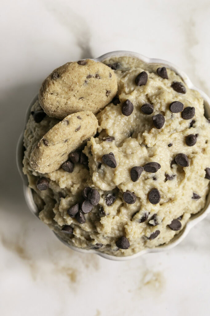 close up overhead shot of High Protein Almond Flour Chocolate Chip Cookie Dough Dip with two mini chocolate chips cookies in it.