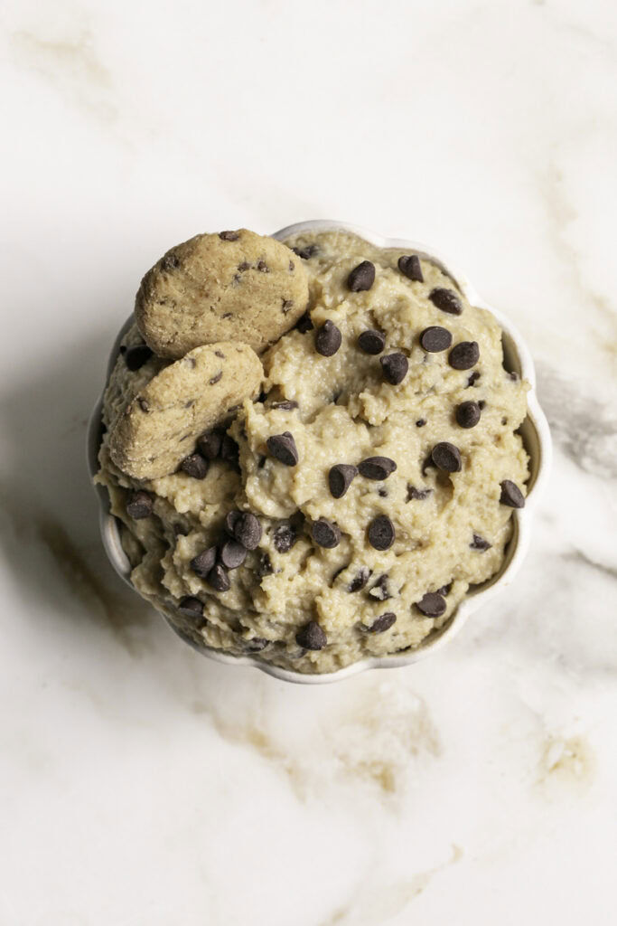 overhead shot of High Protein Almond Flour Chocolate Chip Cookie Dough Dip with two mini chocolate chips cookies in it.