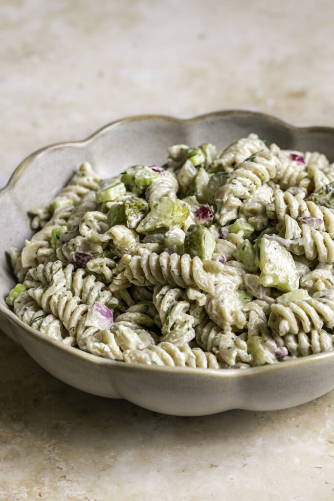 3/4 shot of a bowl of dill pickle pasta salad.
