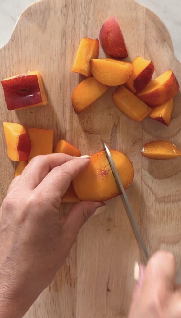 action shot chopping nectarines.