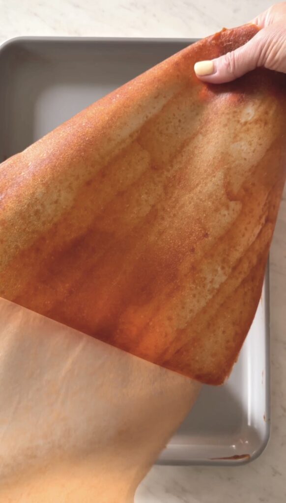 peeling the fruit leather from the parchment paper.