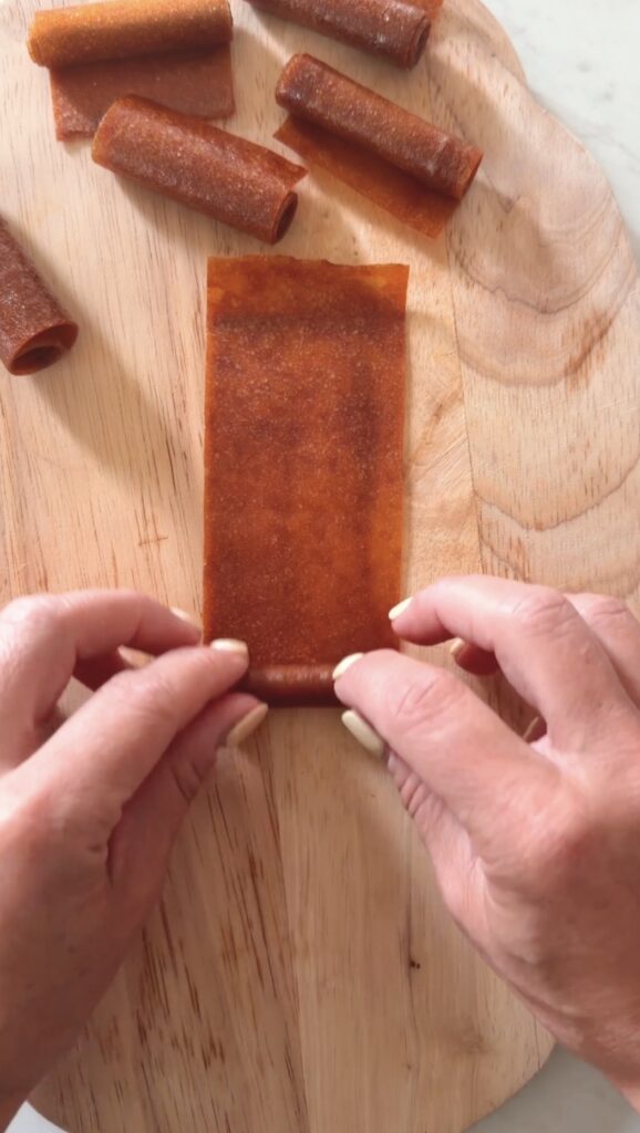 action shot rolling fruit leather.