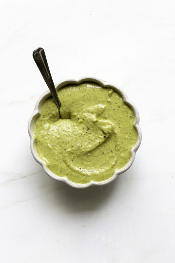 pistachio cream in a small bowl with a spoon.