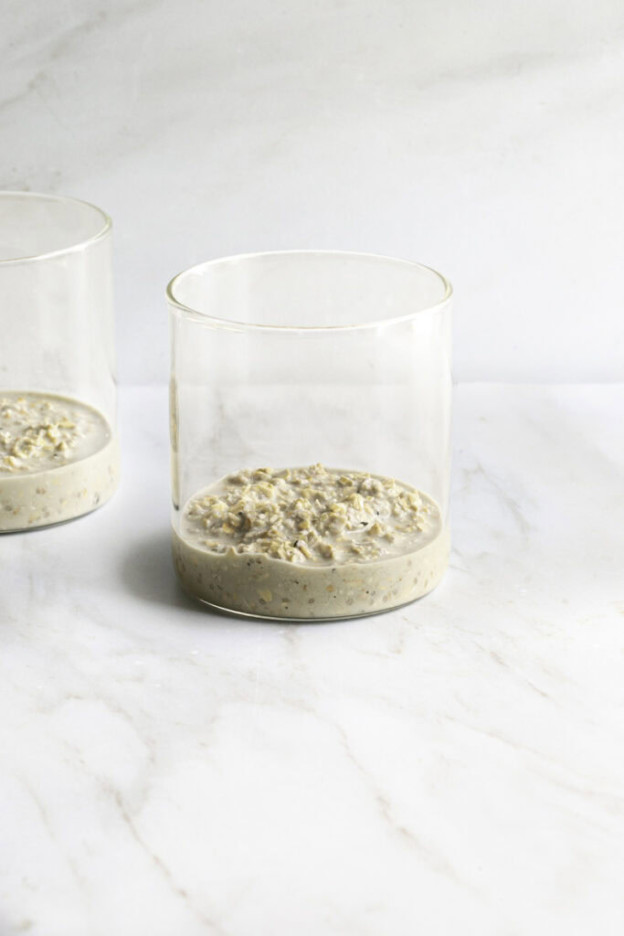 a small amount of overnight oats in glass jars.