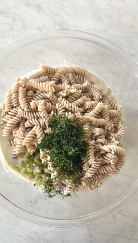 minced dill added to the bowl with the rest of the pasta salad ingredients.