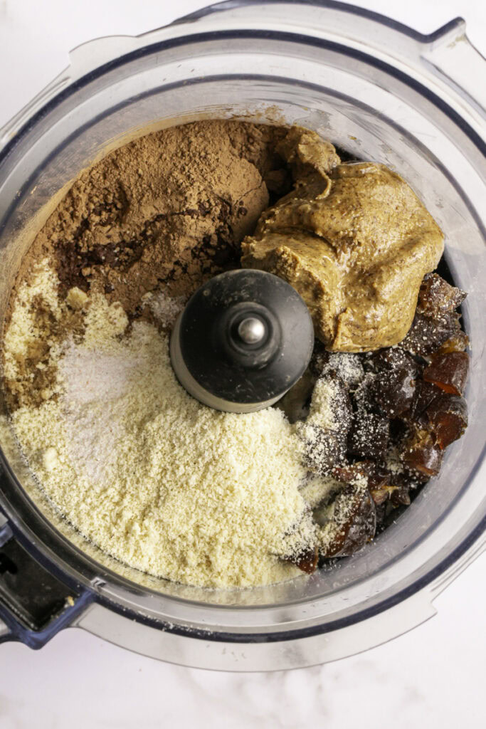 brownie cookie dough ingredients added to a food processor.