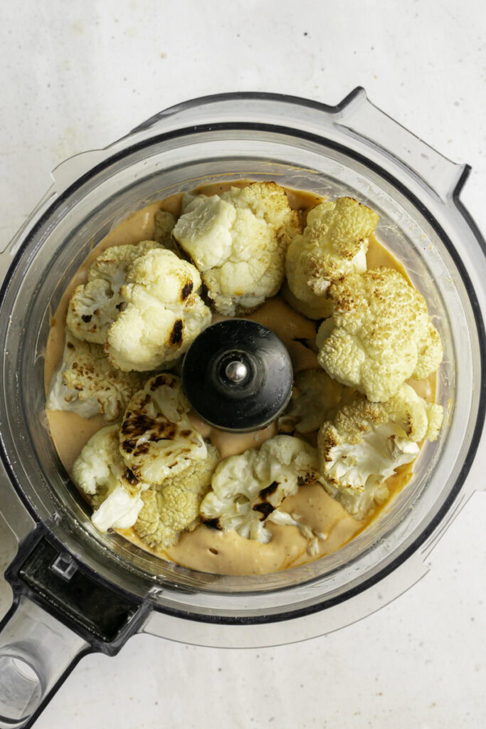 roasted cauliflower added to the food processor with the buffalo sauce.