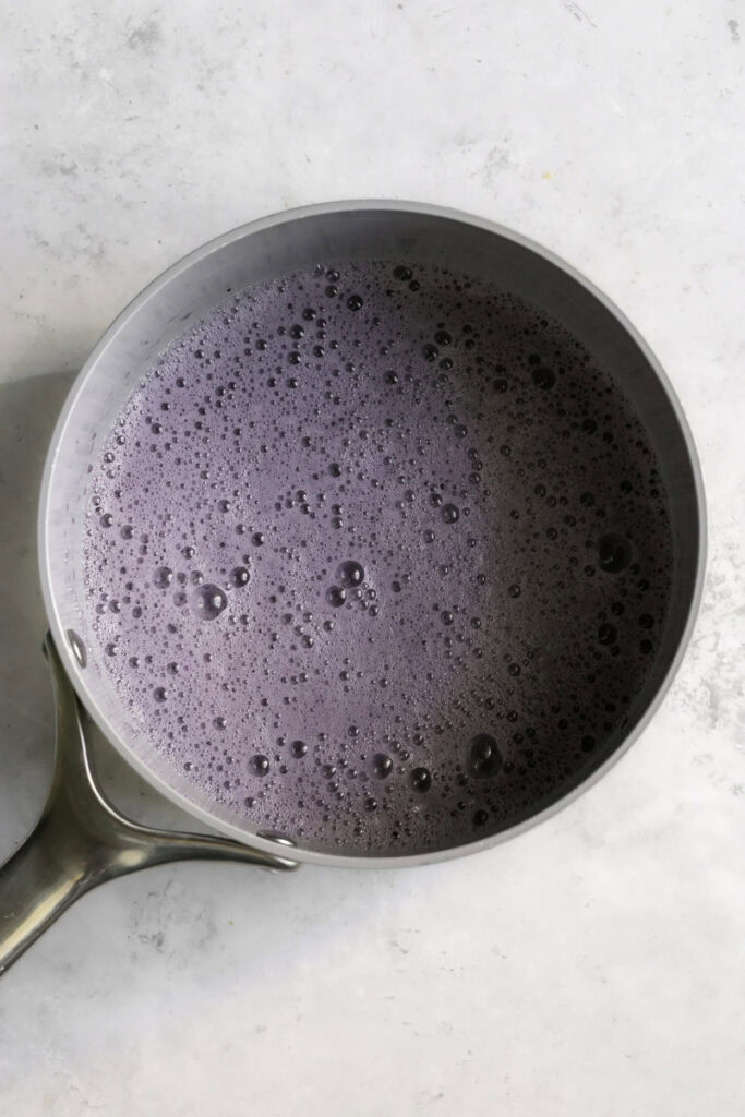a saucepan with the purple colored hot chocolate.