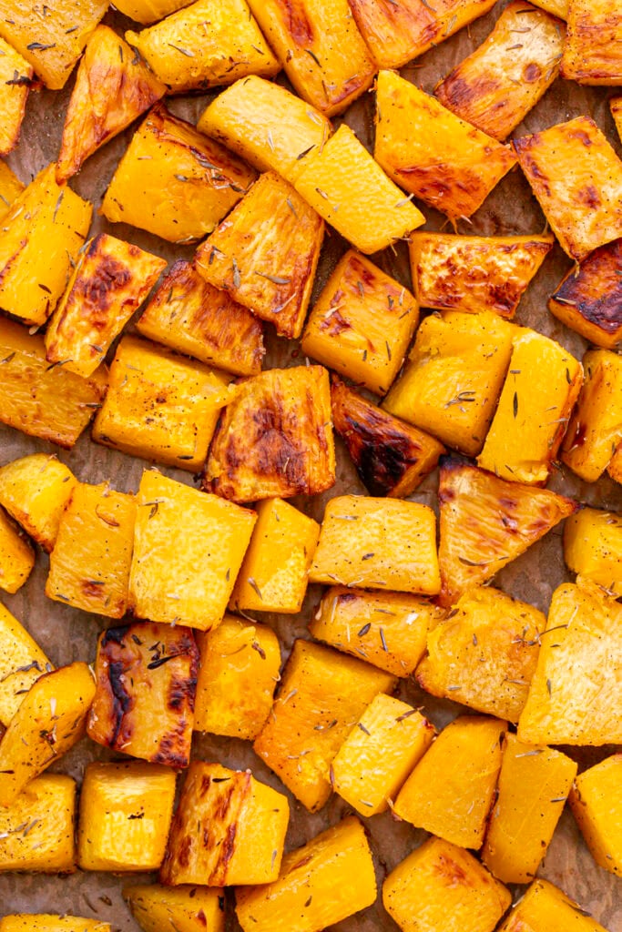 roasted seasoned pumpkin on a baking sheet.