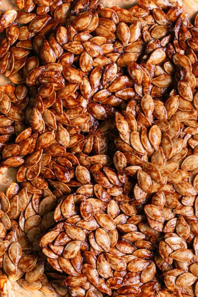 close up shot of Maple Cinnamon Sugar Pumpkin Seed Brittle broken into large pieces.